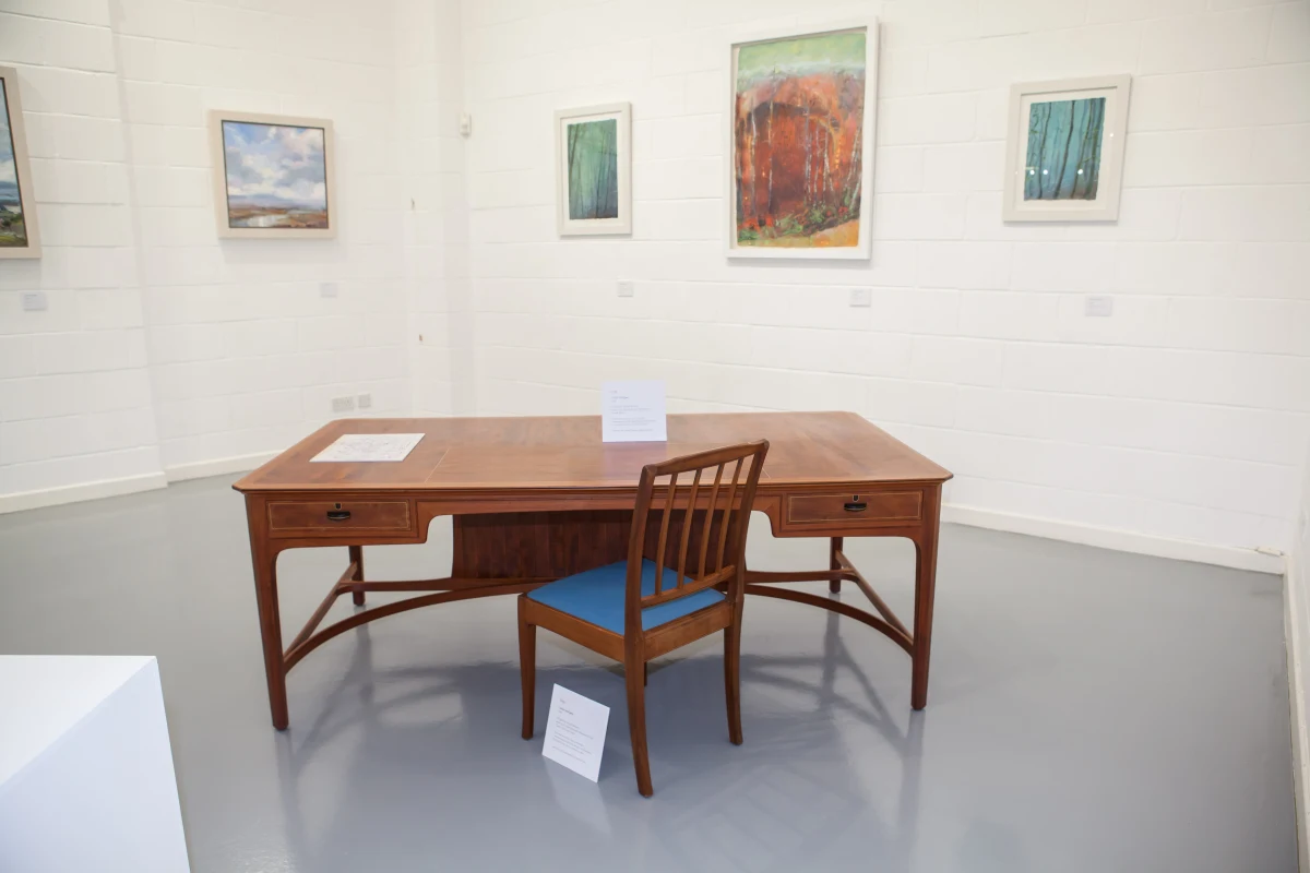 The desk with one of the boardroom chairs